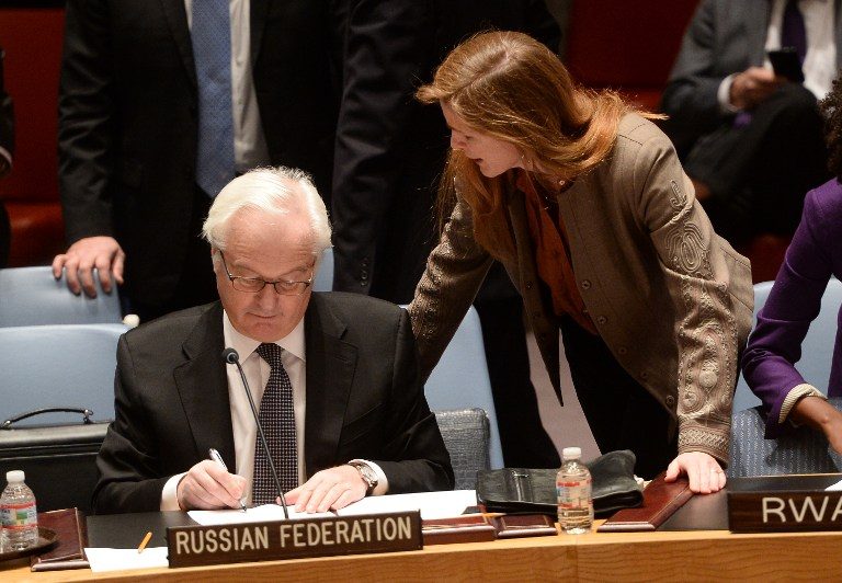 US Ambassador to the UN Samantha Power talks with her Russian counterpart Vitaly Churkin prior to a vote on a resolution on Ukraine during a UN Security Council emergency meeting at United Nations headquarters in New York on March 15, 2014. Russia vetoed a Western-backed resolution condemning the Crimea referendum at a UN Security Council emergency vote but China abstained, isolating Moscow further on the Ukraine crisis. The draft resolution, which says Sunday's referendum would have no validity, got 13 votes in the 15-member Council. But it was rejected when permanent member Russia exercised its veto.   AFP PHOTO/Emmanuel Dunand
