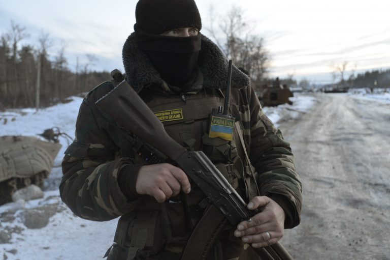 A Ukrainian serviceman stands guard at his position in the village of Luhanska, Luhansk region January 24, 2015. Eastern Ukraine has seen an escalation of fighting in recent days that Russian President Vladimir Putin has blamed on Kiev. The rebels have ruled out more peace talks. Ukrainian President Petro Poroshenko, pledging to protect Ukrainian territory, said he would convene an emergency meeting of his country's security council on Sunday. REUTERS/Oleksandr Klymenko (UKRAINE - Tags: CIVIL UNREST MILITARY POLITICS CONFLICT) - RTR4MRGC