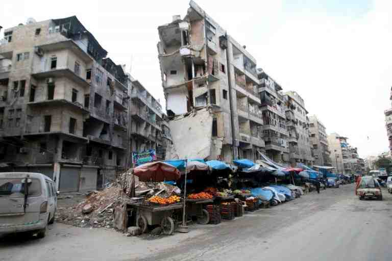 Stalls are seen on a street beside damaged buildings in the rebel held al-Shaar neighborhood of Aleppo, Syria, February 10, 2016. REUTERS/Abdalrhman Ismail
