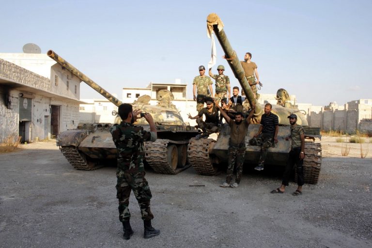 Free Syrian Army fighters take pictures with tanks before heading to the frontline in Aleppo's Sheikh Saeed neighbourhood, September 20, 2013. REUTERS/Molhem Barakat (SYRIA - Tags: POLITICS CIVIL UNREST CONFLICT)