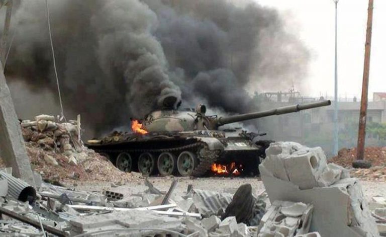 This citizen journalism image provided by The Syrian Revolution against Bashar Assad which has been authenticated based on its contents and other AP reporting, shows a Syrian military tank on fire during clashes with Free Syrian army fighters in Joubar, a suburb of Damascus, Syria, Wednesday, Sept. 18, 2013. (AP Photo/The Syrian Revolution Against Bashar Assad)