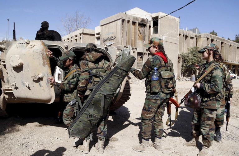 Members of a Female Commando Battalion carry their weapons and supplies as they get into an armored carrier in the government-controlled area of Jobar, a suburb of Damascus March 19, 2015.  REUTERS/Omar Sanadiki
