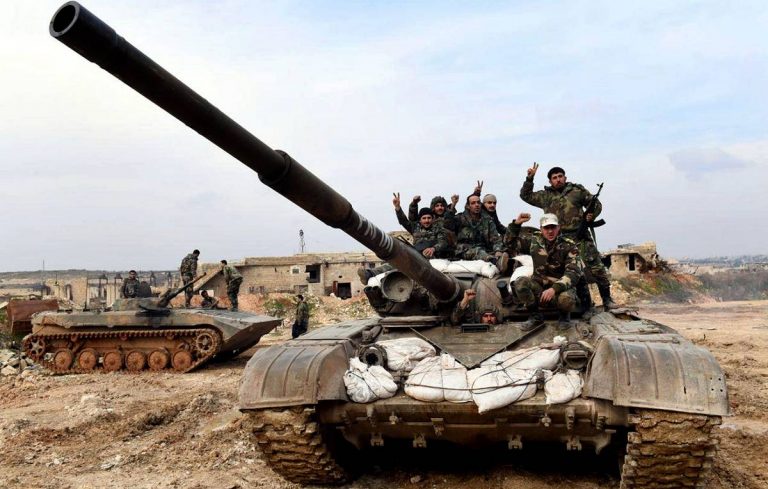 This Monday, Jan. 27, 2020, photo, released by the Syrian official news agency SANA, Syrian army soldiers flash the victory sign as they stand on their tank in western rural Aleppo, Syria. Syrian government forces pressed in their offensive Tuesday, Jan. 28, 2020, closing in on a major rebel stronghold in the northwestern province of Idlib and marching against insurgents west of Aleppo, Syria's largest city, state media and opposition activists said Tuesday. (SANA via AP)