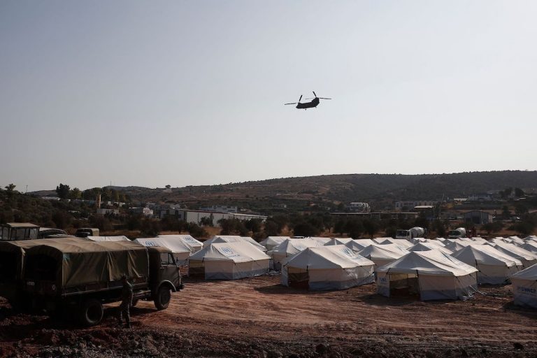 A Greek army's helicopter carrying European Council President flies over the new refugee and migrant camp near Kara Tepe, on the Greek island of Lesbos, days after Europe's largest Moria camp on the island burnt down on September 15, 2020. - The German government confirmed on September 15, 2020, that it has agreed to take in 1,553 refugees from Greece, on top of the 150 unaccompanied minors it will offer refuge to after their camp burned down on the island of Lesbos. (Photo by DIMITRIS TOSIDIS / POOL / AFP) (Photo by DIMITRIS TOSIDIS/POOL/AFP via Getty Images)