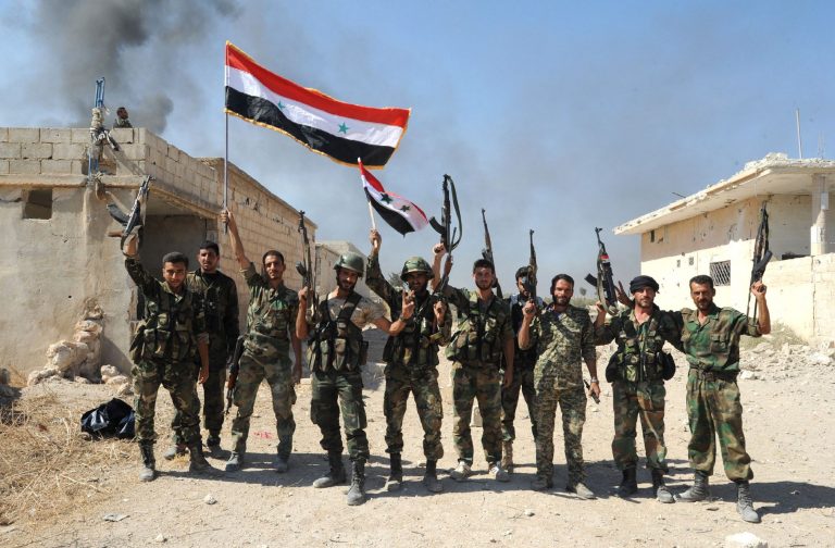 A handout picture released by the official Syrian Arab News Agency (SANA), shows Syrian army units and pro-government forces deploying at an undisclosed location in the Atshan village in central province of Hama,  on October 11, 2015. Regime forces advanced in the central Syrian province of Hama against armed opposition groups in a ground operation backed by Russian air strikes. AFP PHOTO / HO / SANA 
=== RESTRICTED TO EDITORIAL USE - MANDATORY CREDIT 
