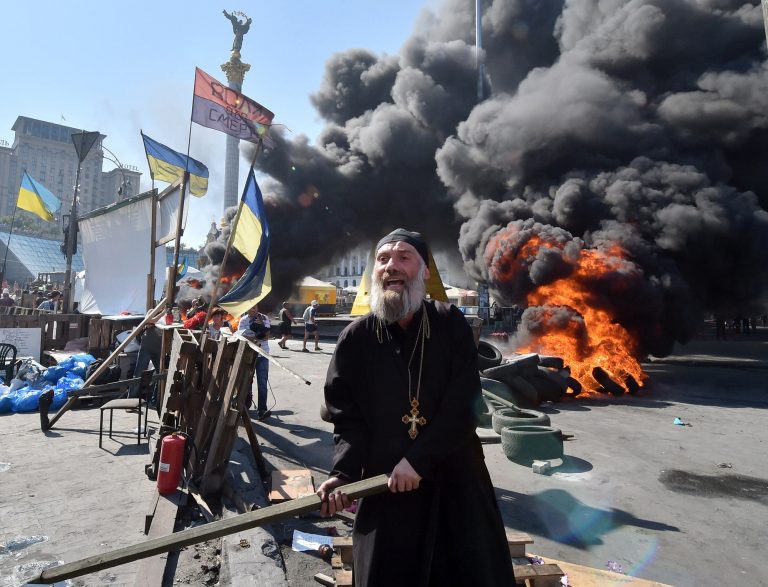 TOPSHOTS
An Orthodox priest gestures with a stick and shouts as Maidan self-defence activists clash with fighters of Kiev-1 volunteer battalion on Independence Square in Kiev on August 7, 2014. Kiev's municipal services protected with the servicemen tried to remove tents from the city's central Independence Square, also known as Maidan, and free Khreshchatyk Street for the traffic. Some few hundreds of Maidan activists still live in the tent camp set in the center of the Ukrainian capital that upsets the vast majority of the local residents. AFP PHOTO/ SERGEI SUPINSKYSERGEI SUPINSKY/AFP/Getty Images