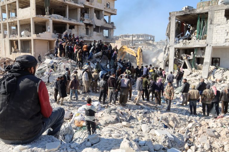 Rescue workers look for survivors amid the rubble of a building in Jindayris, Syria on February 9. (Mohammed Al-Rifai/AFP/Getty Images)