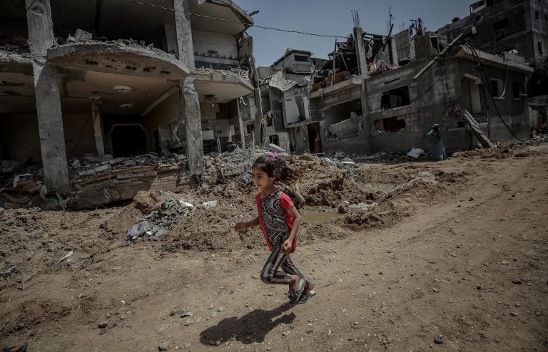 epa09219035 A Palestinian girl run next her family's destroyed house after a ceasefire between Israel and Gaza fighters, in Beit Hanun, northern Gaza Strip, 21 May 2021. After 11 days of fighting a ceasefire came into effect between Israel and militants in Gaza strip under an Egyptian initiative for an unconditional ceasefire. At least 232 Palestinians were killed in the Israeli offensive according to Palestinian health ministry, while at least 12 Israelis killed in rocket attacks from Gaza.  EPA/MOHAMMED SABER