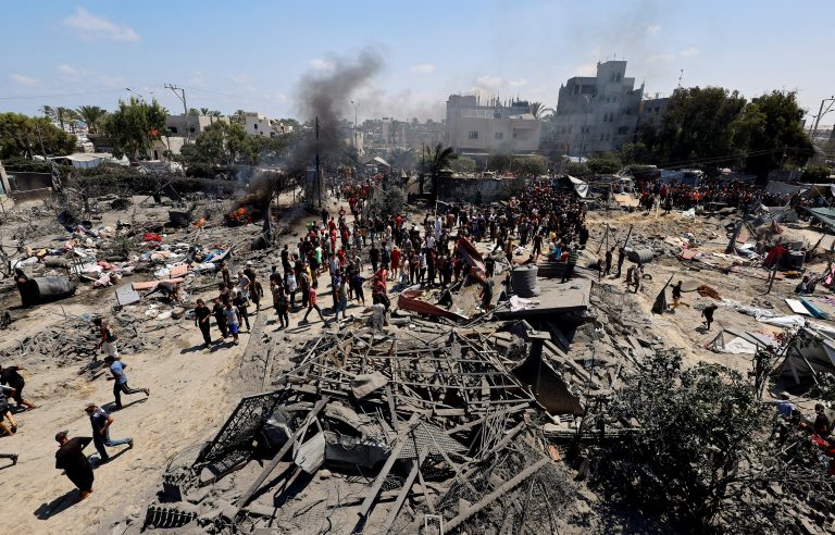 FILE PHOTO: Palestinians gather near damage, following what Palestinians say was an Israeli strike at a tent camp in Al-Mawasi area, amid Israel-Hamas conflict, in Khan Younis in the southern Gaza Strip July 13, 2024. REUTERS/Mohammed Salem/File Photo