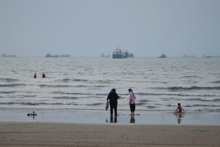 People spend time at a beach as commercial vessels are anchored in the Strait of Hormuz off Bandar Abbas, Iran, Wednesday, Sept. 2, 2026. (Razieh Poudat/ISNA via AP)